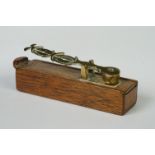 A set of antique brass sovereign scales within a wooden box.