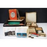 A box of mixed collectables to include an 8 day travel clock, coins, books, ephemera, games, dinky