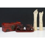 Two Chinese totem poles made from bovine bone, a pair of red resin foo dogs on red resin base and