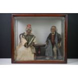 Two late 19th / early 20th century Wax doll type figures in the form of an elderly couple seated