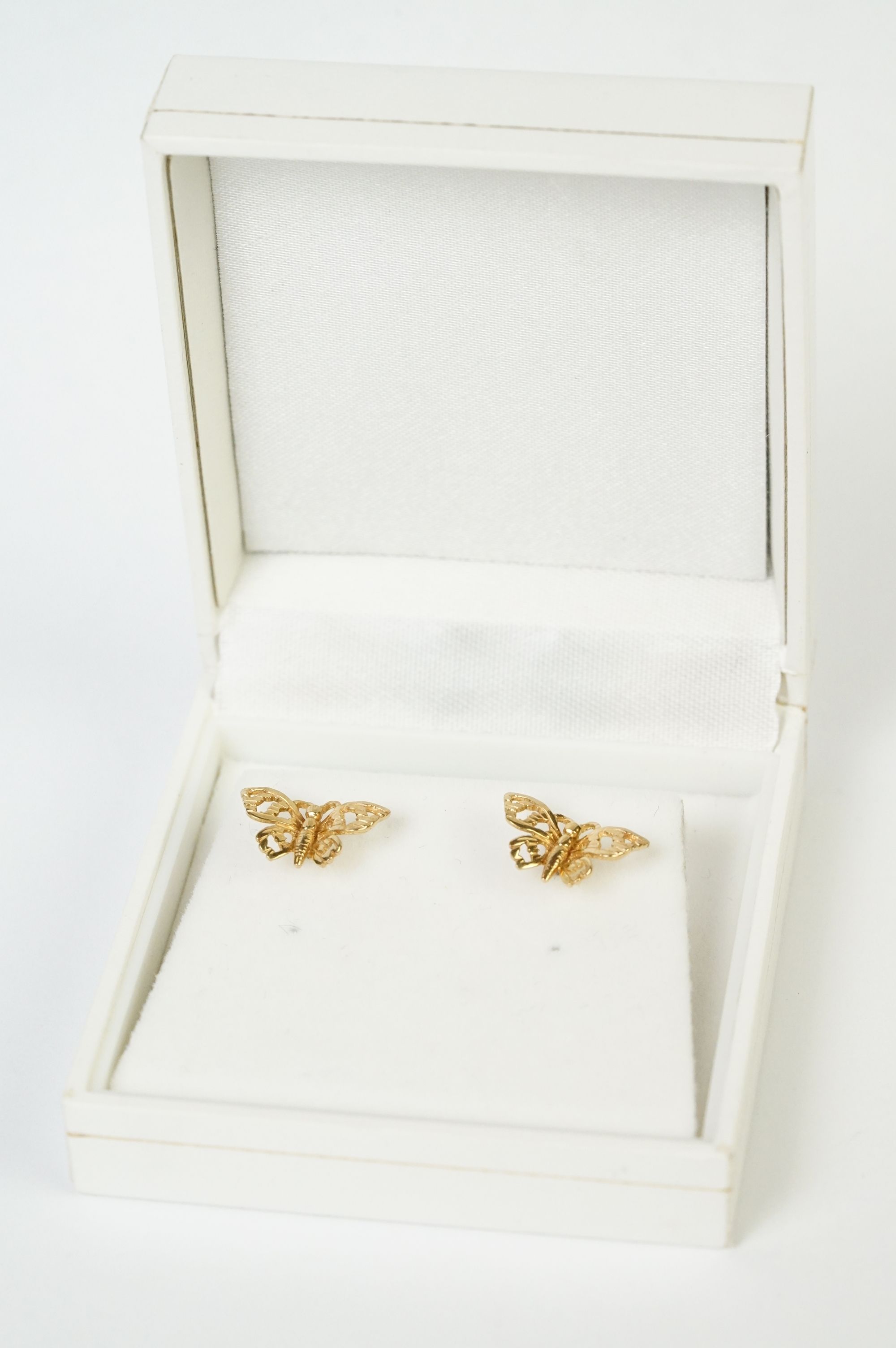 A pair of fully hallmarked 9ct gold stud earrings in the form of butterflies.