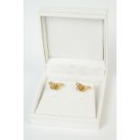 A pair of fully hallmarked 9ct gold stud earrings in the form of butterflies.