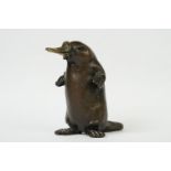 An ornamental bronze figure of a duck billed platypus, signed R.J.J., stands approx 8.5cm in height.