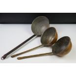 Three large copper ladles to include a pair with brass handles (bowl diameter 15cm, handles approx