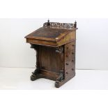 Victorian Rosewood Davenport, the galleried back with pop up stationery cabinet having pigeon