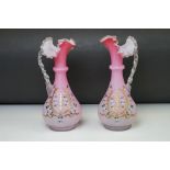 Pair of pink opaque glass baluster vases with single handle, flared frill top, painted with stylised