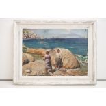 An oil painting of coastal scene with girls by rocks and sailboat in background, 27 x 37cm, framed