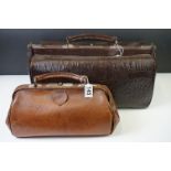 Two early-to-mid 20th century leather Gladstone bags, with leather carry handles, the largest with