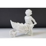 Continental blanc de chine figure of a boy with wheelbarrow, 12cm high