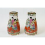 A pair of Chinese famille rose salt and pepper pots, with character marks to the base.