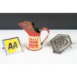 A small Shell X-100 motor oil jug together with two vintage AA car badges.