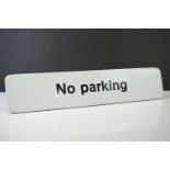 ' No parking ' enamel sign, with black lettering on white ground. Measures approx 55cm long