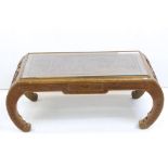 South East Asian Hardwood Coffee Table with curved end supports and carved with figures, with