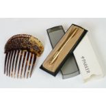 A cased vintage rolled gold Parker pen together with a faux tortoiseshell hair comb.