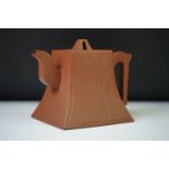 Chinese Yixing teapot of square tapered form, one side decorated overall with incised calligraphy