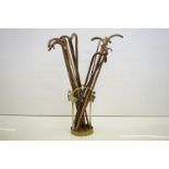 A brass stick stand with art nouveau naturalistic form together with a collection of walking sticks.