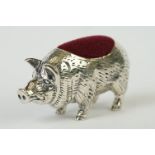 A silver pig pincushion