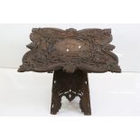 19th century Anglo - Indian Hardwood Square Table, the shaped top profusely carved with flowers