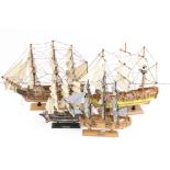 A collection of four wooden model ships.