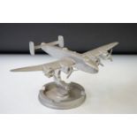 Vintage solid cast metal model aircraft, raised on a circular base (21.5cm nose-to-tail)