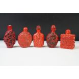 A collection of five cinnabar lacquer perfume bottles.