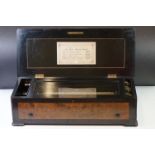 19th Century Swiss six-airs music box, the walnut veneered lid opening to a 33cm long cylinder and