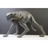 Bronzed brass garden figure of a dog (possibly greyhound) with head turned toward hind leg. Measures