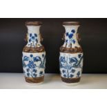 Pair of Chinese two handled, blue and white crackle glazed vases, painted with dragons, flowers