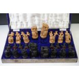 Cased set of Asian carved sandalwood chess pieces, the pieces of figural form (to include figures