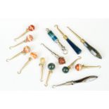 A collection of antique button hooks with decorative agate finials.