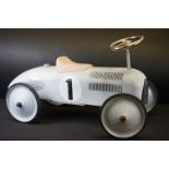 Contemporary ride on metal race car, race number 1, in weather silver