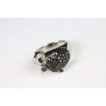 A silver CZ and panther head designer style ring.