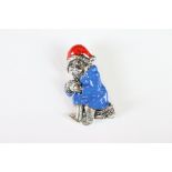 A silver and enamel Paddington bear style brooch.