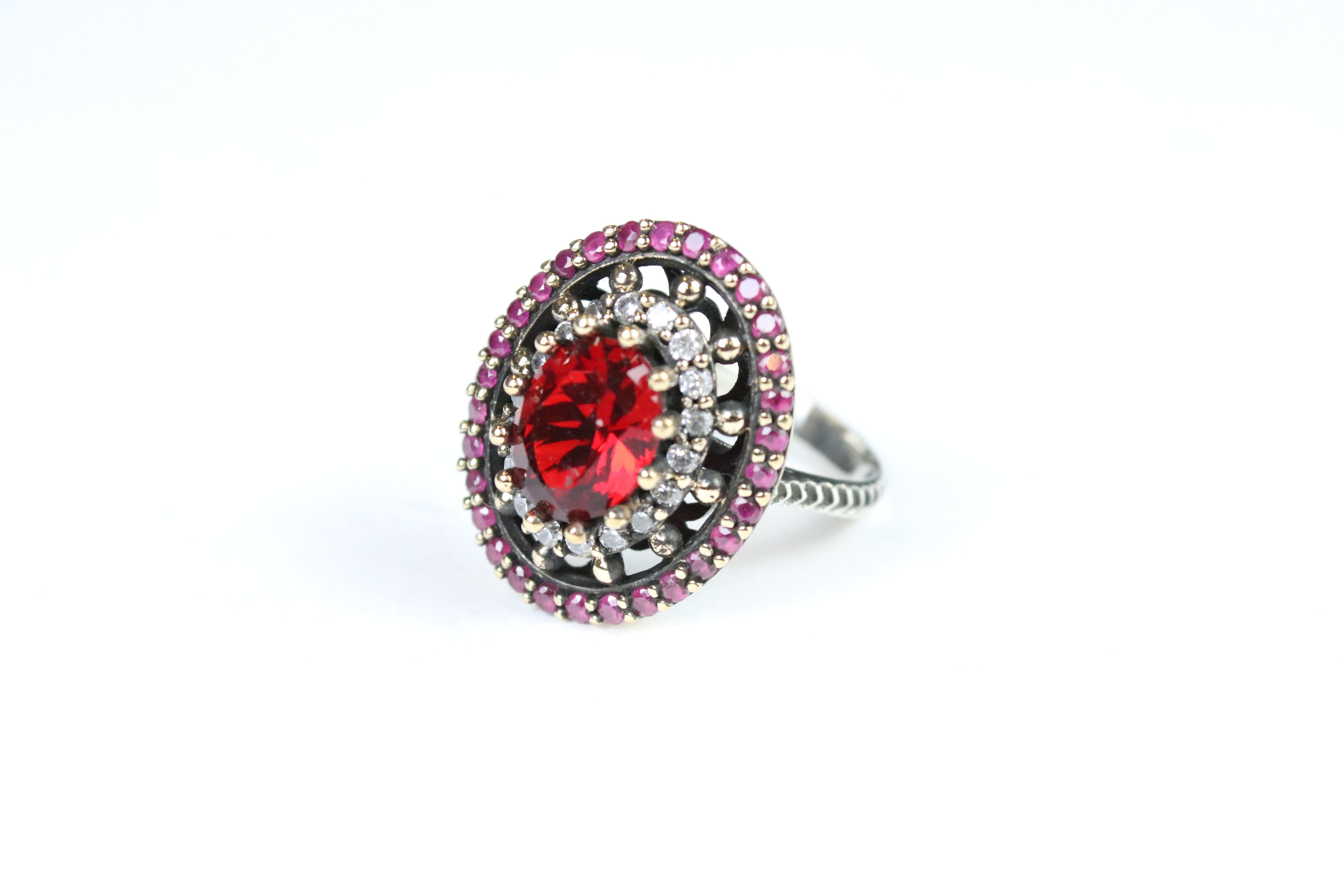 A large silver CZ and garnet dress ring