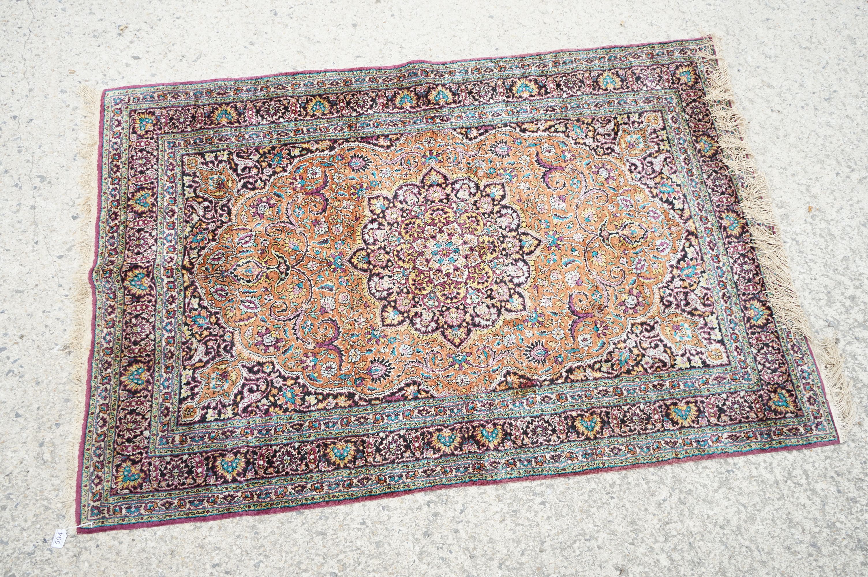 Indian Silk Kashmir Rug decorated with a central cartouche and a dense floral pattern within a