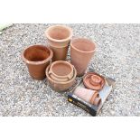Quantity of terracotta plant pots and saucers, heights vary