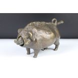 A bronze table top bell in the form of a pig.