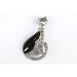 A silver marcasite and onyx cat brooch.