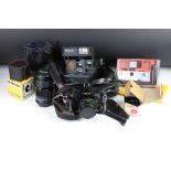 A Canon A-1 35mm SLR camera together with a quantity of photographic accessories.