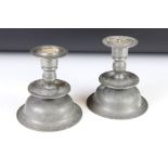 A pair of 17th century style pewter candle sticks of low bell form.