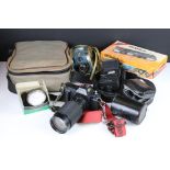 A collection of vintage photographic equipment to include a Canon T50 35mm SLR camera with lens