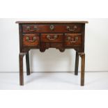 George III Mahogany Lowboy, the moulded top over an arrangement of four drawers, shaped apron and
