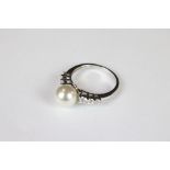 A silver CZ and freshwater pearl dress ring.