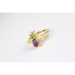 A gold plated on silver bug ring set with peridot and amethyst.