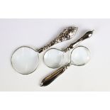 A set of three silver plated magnifying glasses.
