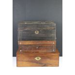 A wooden box with brass swing handles, the two tier interior lined with burgundy silk and velvet and