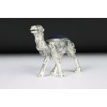 A large silver plated camel style pincushion.