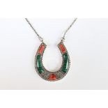 A silver horseshoe shaped necklace set with malachite and agate.