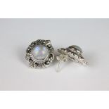 A pair of silver moonstone stud earrings.