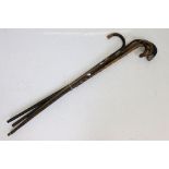 Five early 20th century wooden walking sticks to include three silver mounted examples (featuring